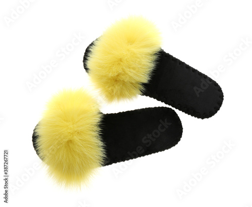 Pair of soft open toe slippers with yellow fur on white background, top view