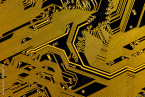 Fototapet Golden conductive tracks on a black circuit board, abstract background