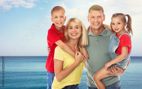 Happy family near sea on sunny day. Summer vacation