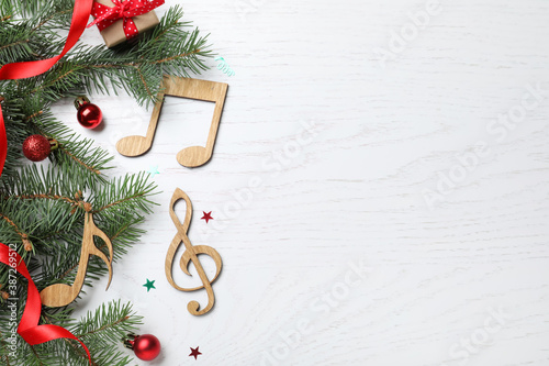 Fotografie Flat lay composition with music notes on white wooden background, space for text