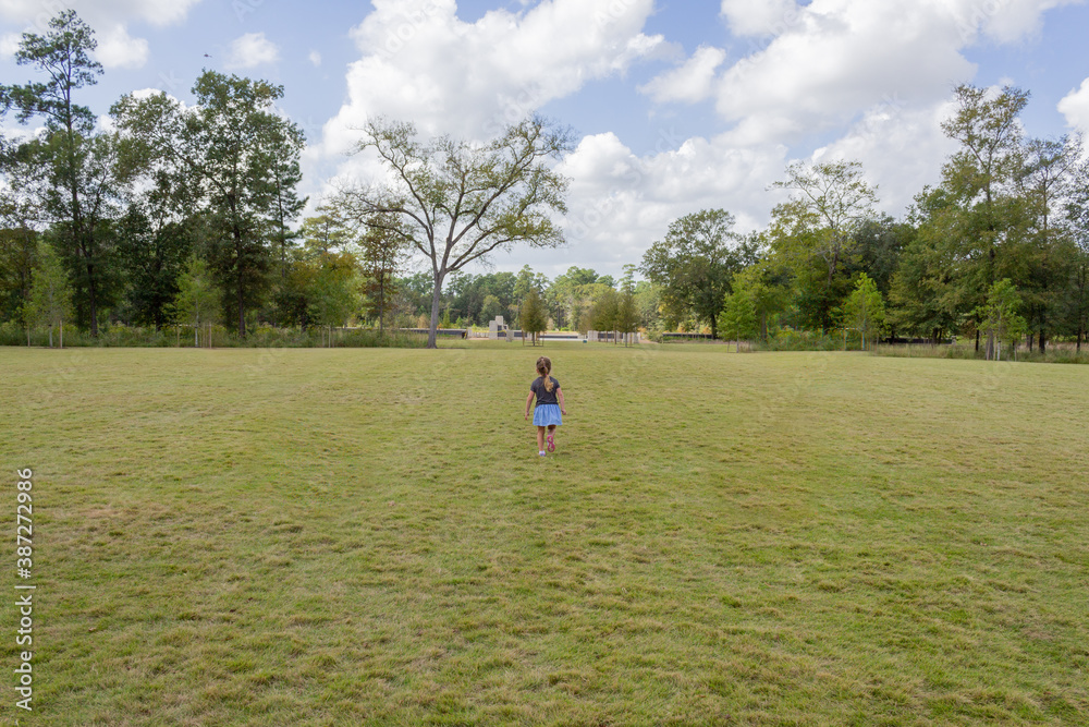 Child Walking in a Field of Grass