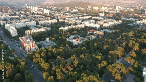 Parks and streets lined with evergreen trees in a sustainable eco city planned with green urbanism in mind. Aerial view of a residential district in Podgorica Montenegro, Europe.
