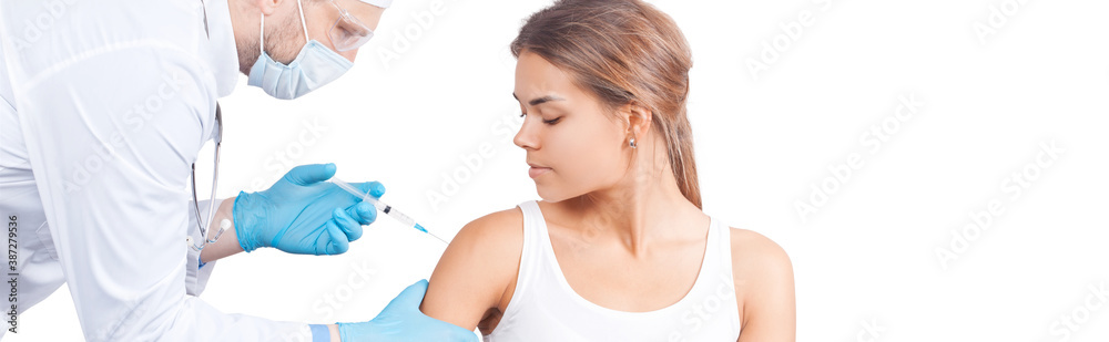 Doctor gives a syringe with vaccine to patient at clinic. Doctor gives a syringe with vaccine to patient at clinic.