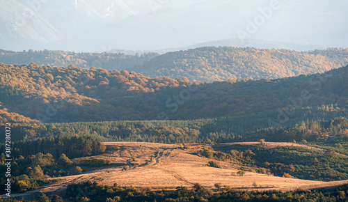 clear blue air over mountains in bulgaria crops hay fields clouds blue sharp focus distance superzoom copy space for text minimal landscape rural