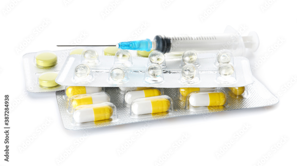Pills and syringe for injection on white background Pills and syringe for injection on white background