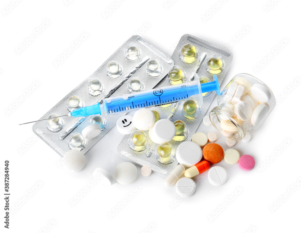Pills and syringe for injection on white background