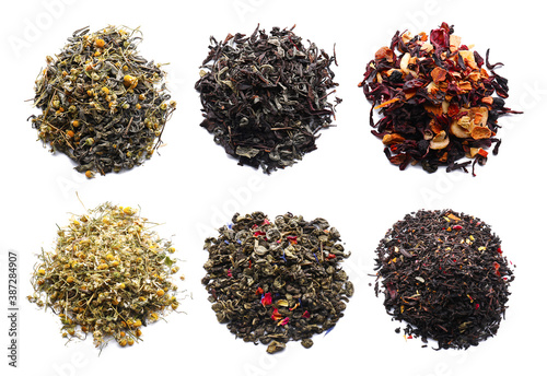 Different dry tea leaves on white background