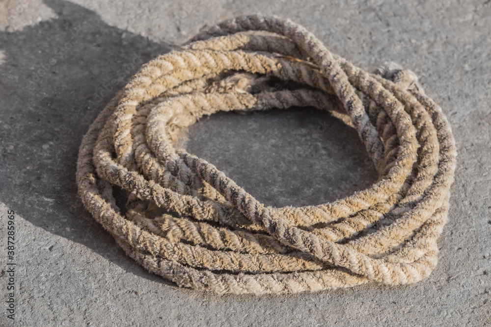 Old hemp rope coiled in a circle Stock Photo