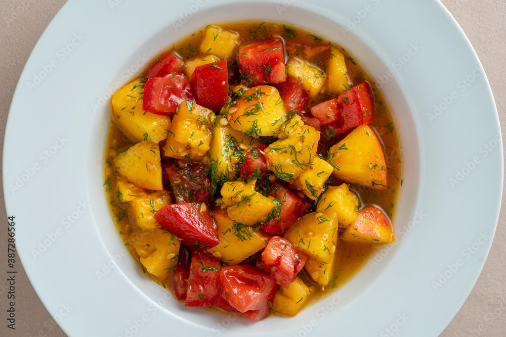 Colorful summer salad with tomato and peach, close up. Top view. Colorful summer salad with tomato and peach, close up. Top view.