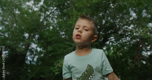 Cute little boy singing with microphone. Red cinema camera 4k