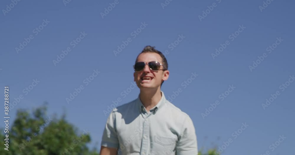 Young pretty man is singing and dancing in summer park 4k Young pretty man is singing and dancing in summer park 4k