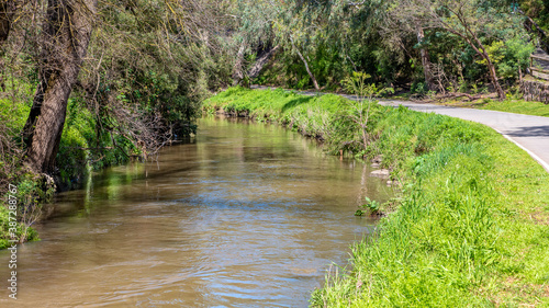 A calm tranquil scene of Merri Creek flowing through the suburbs of Melbourne Australia photo