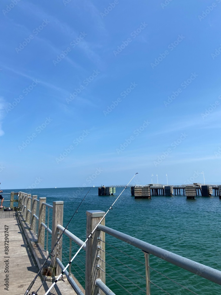 wooden pier with propped fishing pole