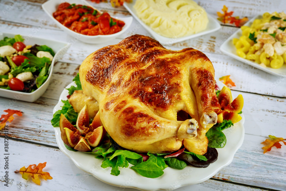 Thanksgiving turkey on festive table with salad.