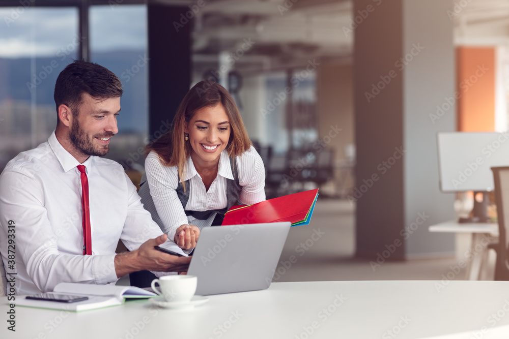 Couple of busy colleagues working together in modern office Couple of busy colleagues working together in modern office