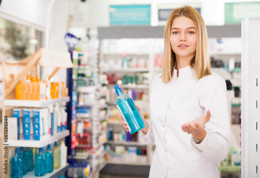 Cheerful female pharmacist demonstrating assortment of pharmacy. High quality photo