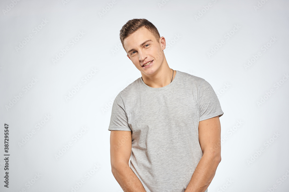 man in gray t-shirt emotions light background cropped view
