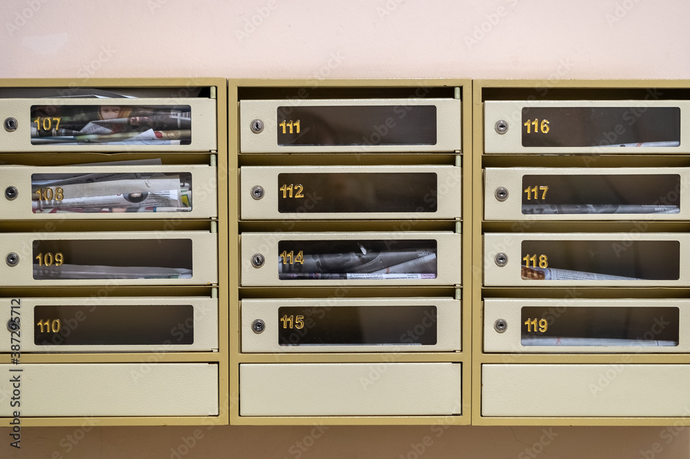 Metal mailboxes in the lobby of a residential building. numbered letterbox front view. letters, paper advertising, newspapers delivery. Metal mailboxes in the lobby of a residential building. numbered letterbox front view. letters, paper advertising, newspapers delivery.