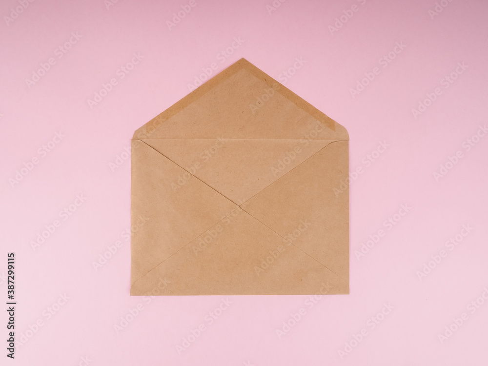 Brown craft envelope on a pink background Brown craft envelope on a pink background