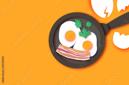 Bacon, eggs and cooking pan with handle. Omelet papercut style. Farm products. Fast food. Natural product. Food ingredients. Smiling breakfast. Orange background.