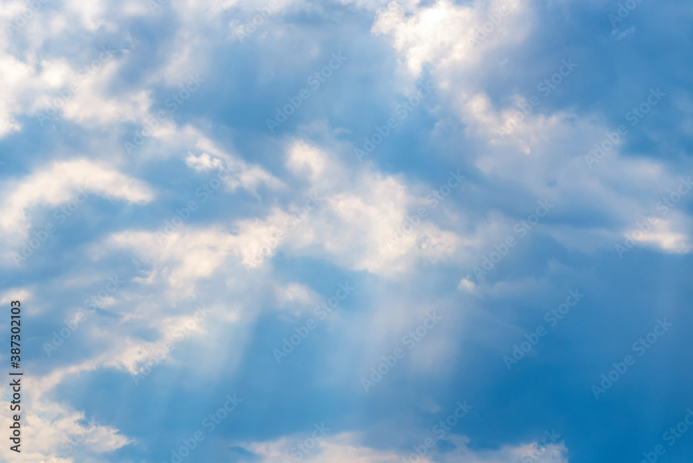 Sunbeams falling from the clouds on the blue sky