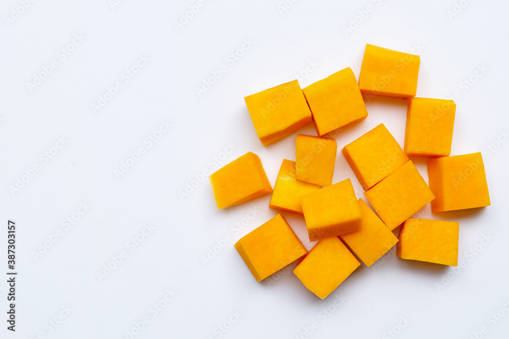 Cut and slices butternut squash on white background.