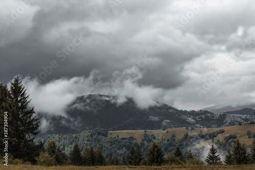 Dark skies ready to pour doge on mountain plains and peaks. Always rainy weather in early autumn in the Ukrainian Carpathian Mountains.