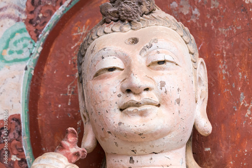 smiling buddha closeup in maiji mountain grottoes photo