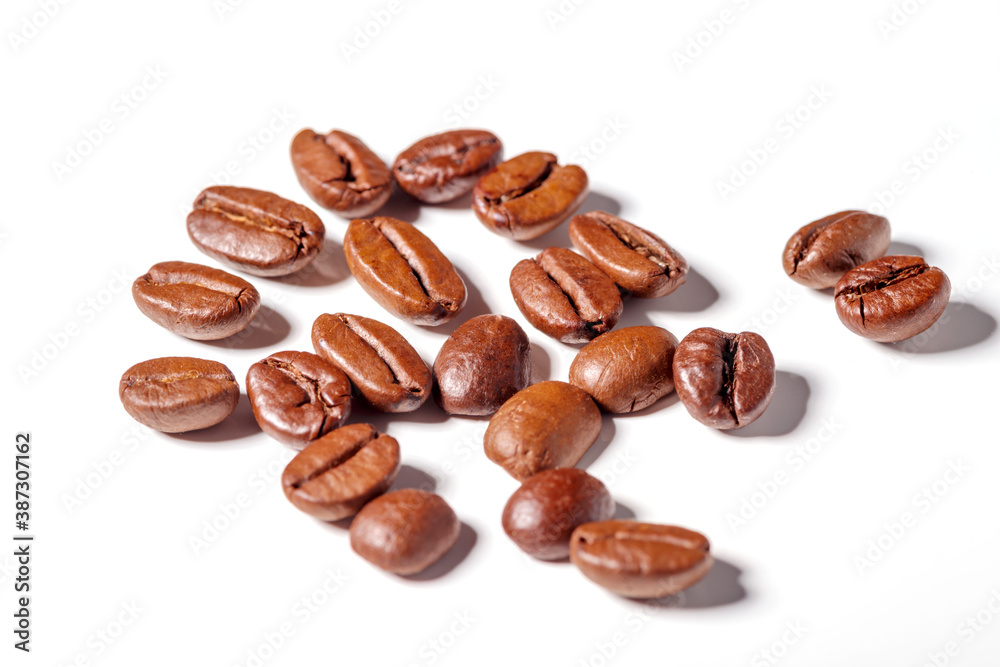 Heap of fresh roasted coffee beans isolated on white background as package design elements Heap of fresh roasted coffee beans isolated on white background as package design elements