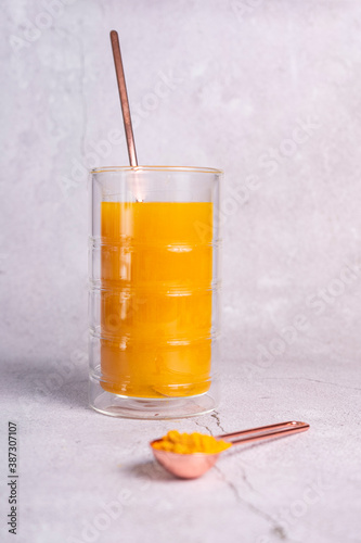 selective focus. honey cake with delicate cream. on a light background with craft paper. in the background is a jar of light honey photo