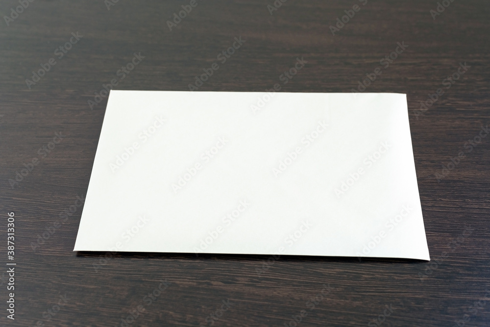 One empty blank sheet of paper placed on the dark wooden surface of the office desk. Empty layout mockup on textured vintage paper surface. Watercolor paper template top view with copy space One empty blank sheet of paper placed on the dark wooden surface of the office desk. Empty layout mockup on textured vintage paper surface. Watercolor paper template top view with copy space