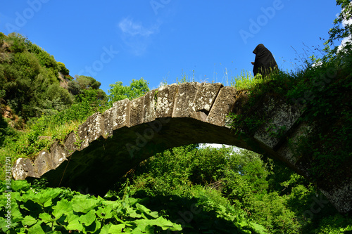 Pellegrino sul ponte antico della via Clodia photo