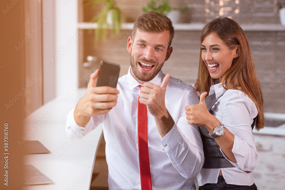 beautiful business workers working together using laptop at the office doing happy thumbs up gesture with hand. beautiful business workers working together using laptop at the office doing happy thumbs up gesture with hand.