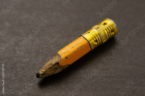 a small remnant of a yellow pencil on the table.