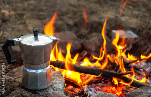Coffee in a geyser over a fire. Geyser with coffee in nature. Traveling with coffee. Hot coffee from the fire. Picnic. the fire 