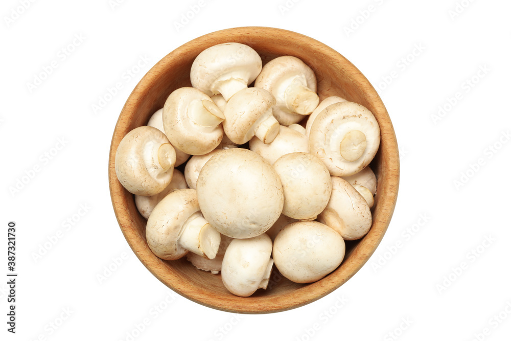 Wooden bowl of champignons isolated on white background