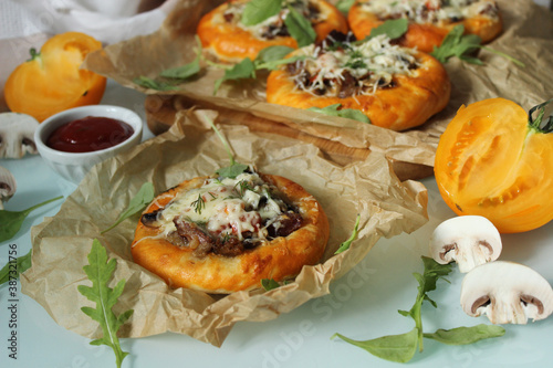 Rustic pastries with mushrooms and meat and decorated with cheese close-up