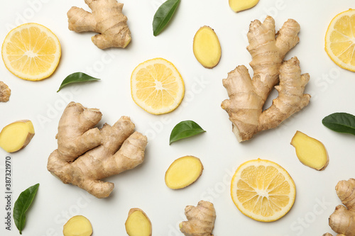 Fresh ginger and lemon on white background, top view