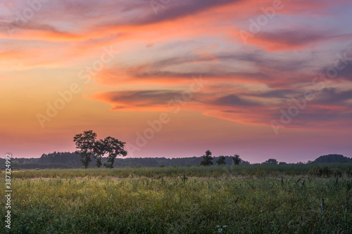 beautiful sunset sky over fields and meadows