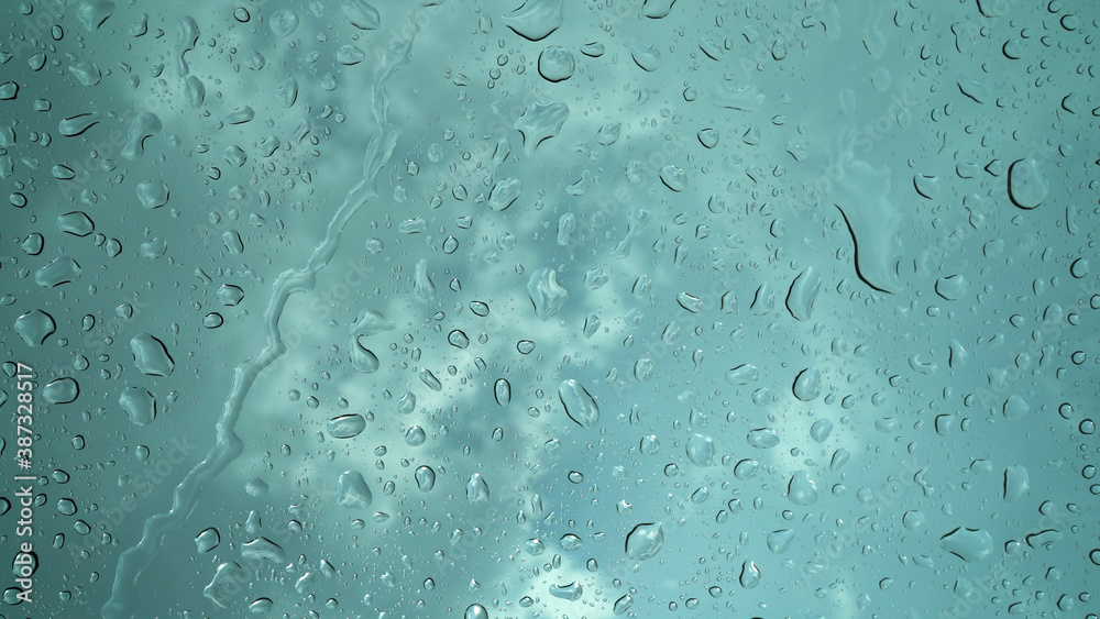 Rain droplets falling on the glass, a rainy day in autumn Rain droplets falling on the glass, a rainy day in autumn