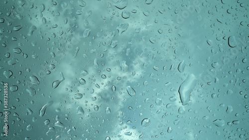 Rain droplets falling on the glass, a rainy day in autumn
