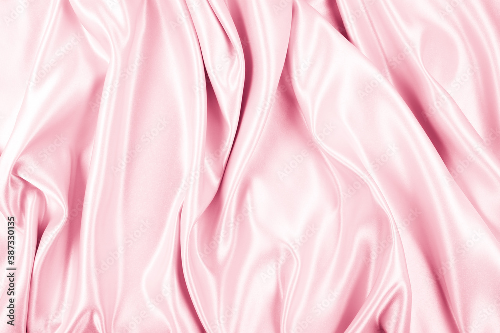 Obraz premium Beautiful elegant wavy light pink satin silk luxury cloth fabric texture, abstract background design. Copy space