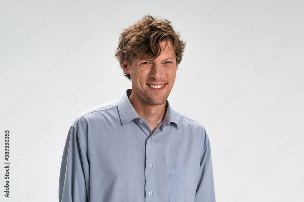 Cheerful man smiling broadly isolated on white background. Copy space at right. Cheerful man smiling broadly isolated on white background. Copy space at right.