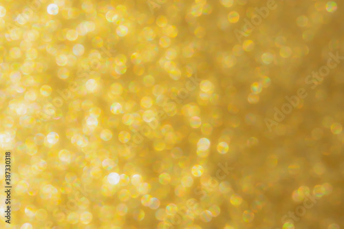 Abstract Christmas Golden background with bokeh. Festive bright and Sunny with a defocused background. Atmospheric design of greeting cards, banners for the New year. The concept of the celebration.