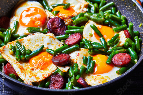 Breakfast of green beans baked eggs and chorizo