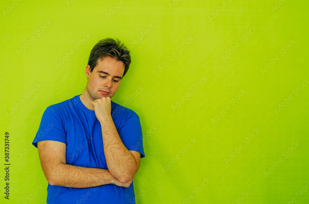 Sad Thoughtful Redhead Flabby Guy Isolated in Green Background With Hand on Chin Sad Thoughtful Redhead Flabby Guy Isolated in Green Background With Hand on Chin