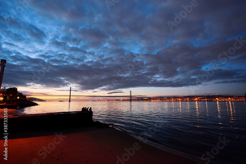 Beautiful landscape with Tagus river promenade in Lisbon at sunset.