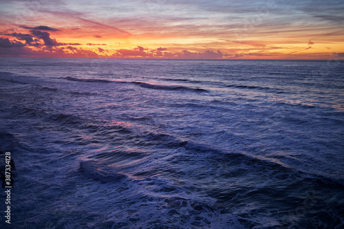 Amazing colorful sunset on ocean shore.