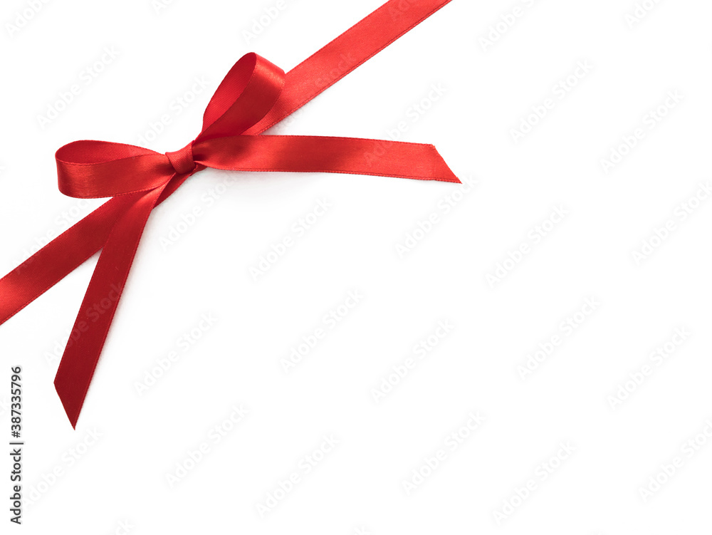 Shiny red satin ribbon bow isolated on white with copy space for your text. Shiny red satin ribbon bow isolated on white with copy space for your text.