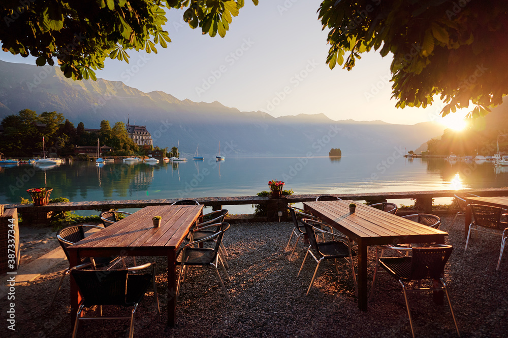 Wooden cafe tables on the bay of Brienz lake, Switzerland.